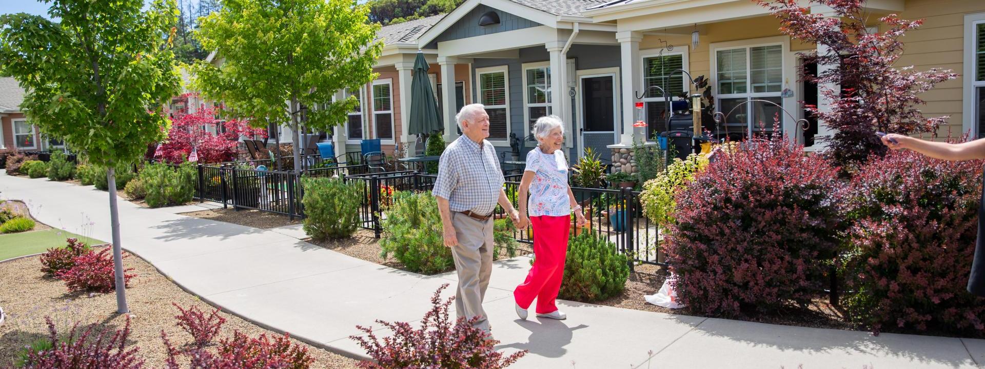 Resident couple walking holding hand and hand.