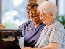 Resident playing the piano while staff sings