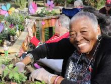 Resident planing flowers in the planters