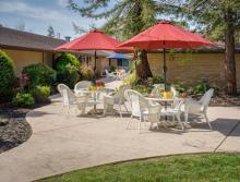 Outdoor patio with tables, chairs and umbrellas