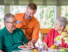 Couple being served in the dining room.