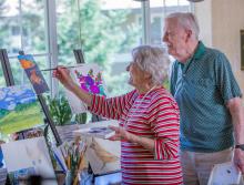 Resident couple painting a picture.