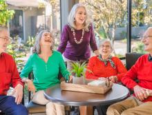 Five residents talking and laughing