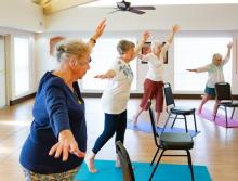 Women in an exercise class doing balancing exercises