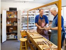Two men working together in the wood work shop