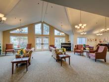 Sitting room with couches, chairs and a piano