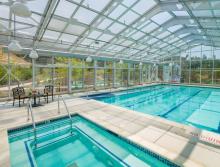 Indoor pool and spa with patio table and chairs