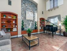 Eskaton Village Roseville's beautiful front lobby sitting area with a couch and two chairs.
