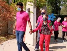 Staff and residents walking outside, around the community
