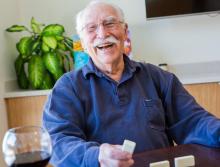 Happy and smiling resident playing Domino