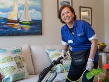  Housekeeping staff vacuuming an apartment