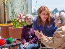 Smiling staff and residents listing to music with headsets