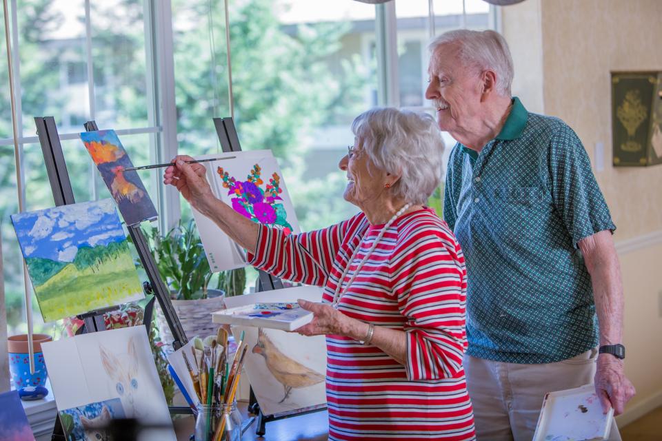 Male and a female resident painting on canvas 