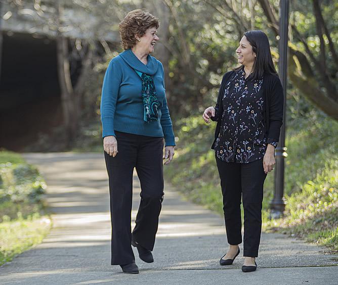 Linda Whiteside walking in the park with a friend