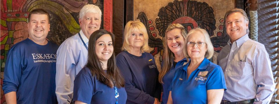 Seven leadership staff smiling