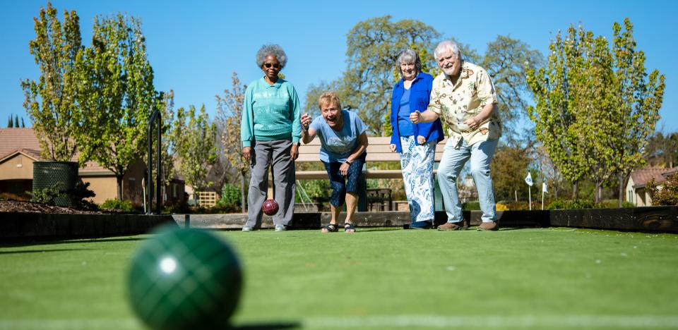 Four residents playing Bocce ball