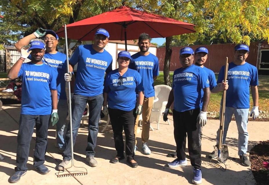 A group of volunteers from Intel  wearing the t-shirts "Do Wonderful Intel Involved" with racks and shovels