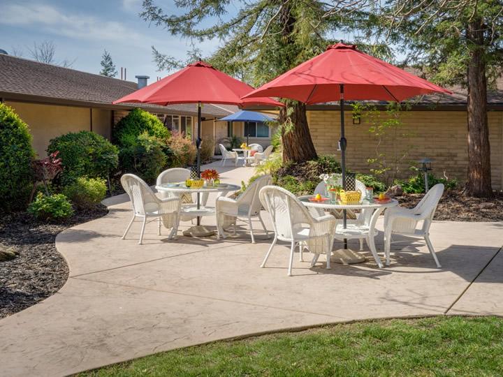 Outdoor patio with tables, chairs and umbrellas