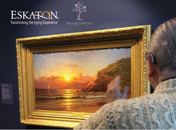 Man looking at a painting of the sun rising over the ocean.