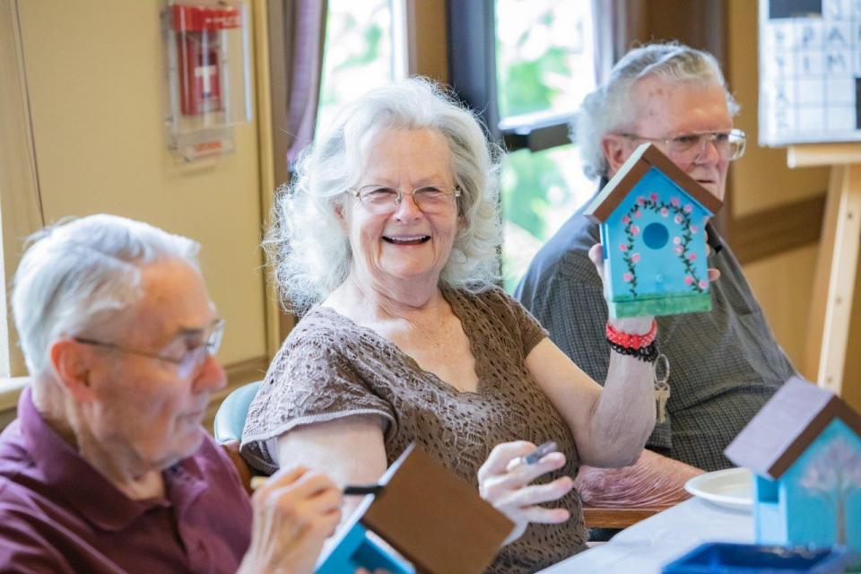 Residents painting bird houses