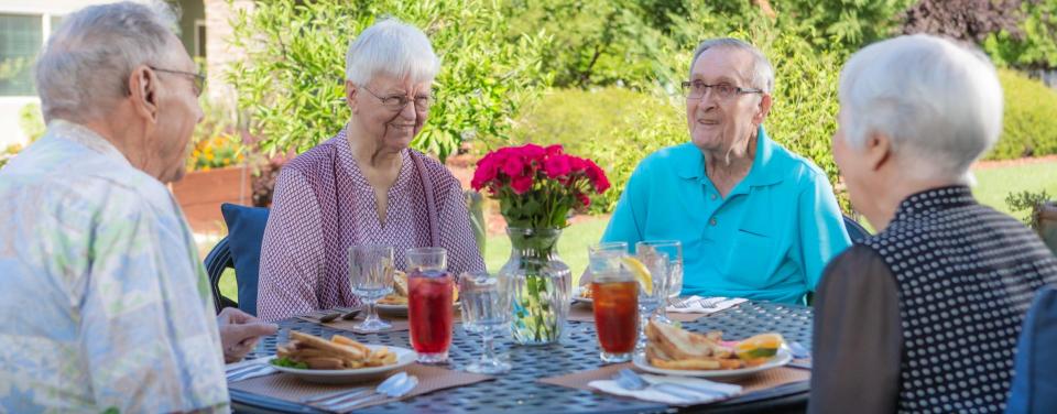 Two couples having lunch on the patio