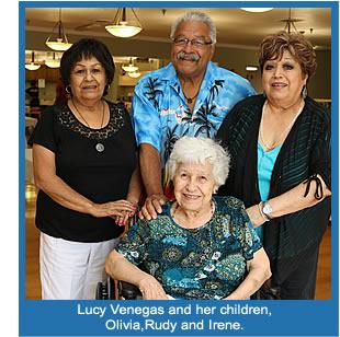 Smiling resident, Lucy, with her two daughter and one son.