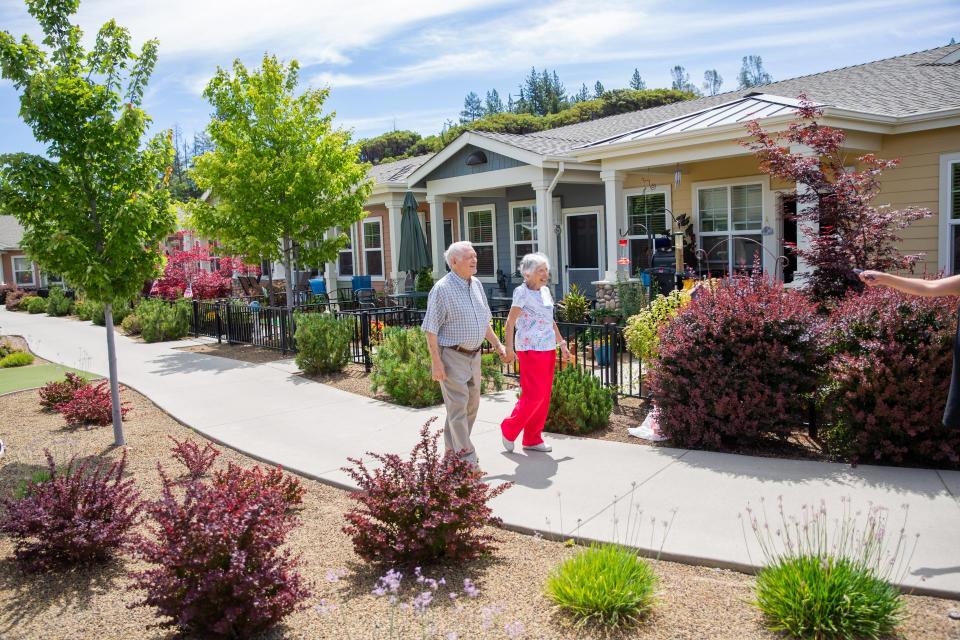 Resident couple walking holding hand and hand.