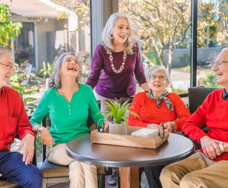 Five residents talking and laughing