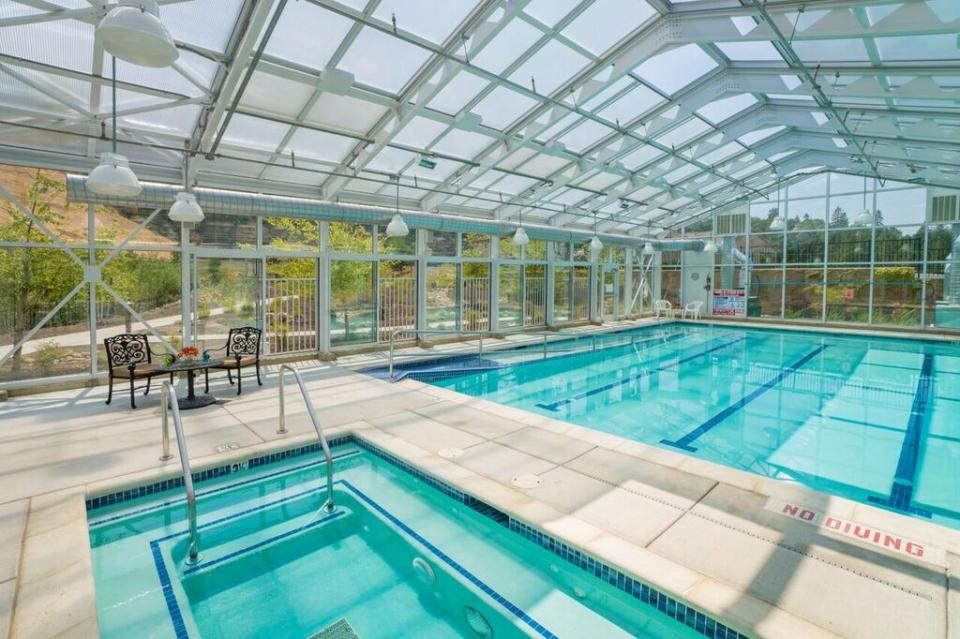 Indoor pool and spa with patio table and chairs