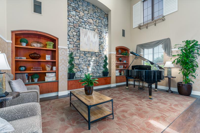 Eskaton Village Roseville's beautiful front lobby sitting area with a couch and two chairs.