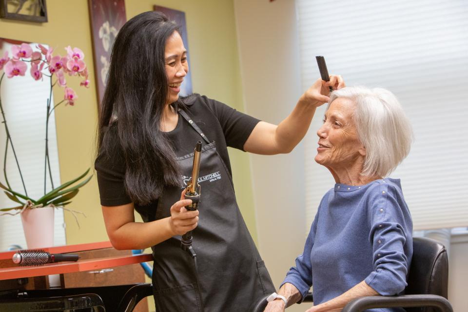 A woman resident getting her hair done in the community's salon.