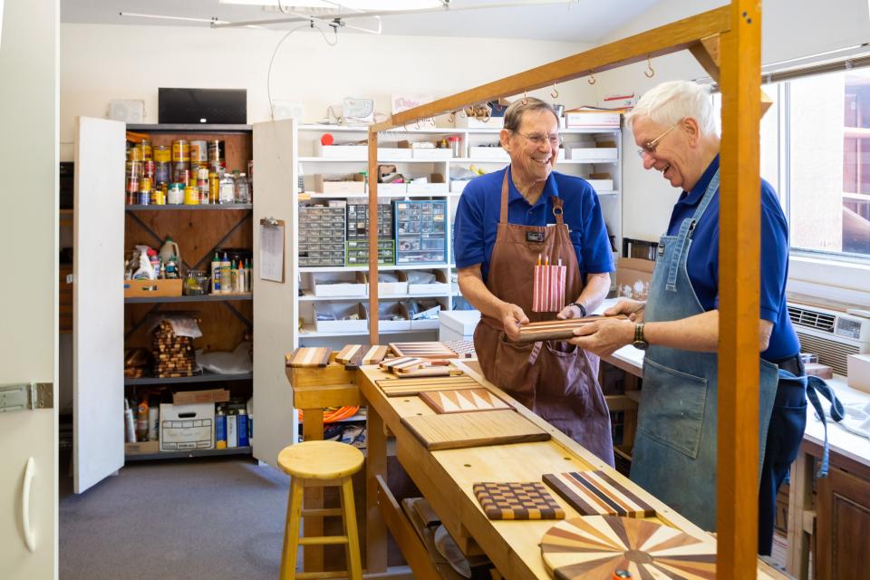 Two men working together in the Village woodwork shop