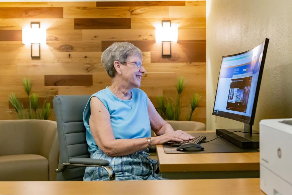 woman at a computer looking up community activities