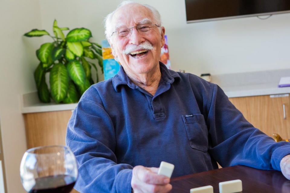 Happy and smiling resident playing Domino