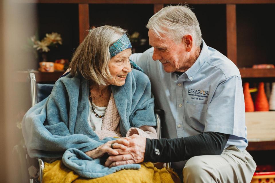 Community Chaplin smiling and talking with a woman resident