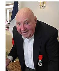 Resident Guy in a tux with a red rose in the lapel of his jacket. 