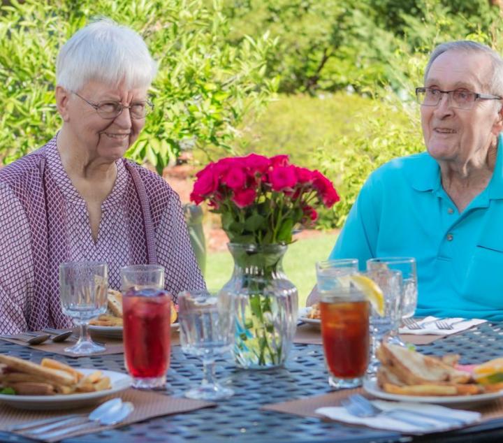Two couples having lunch on the patio