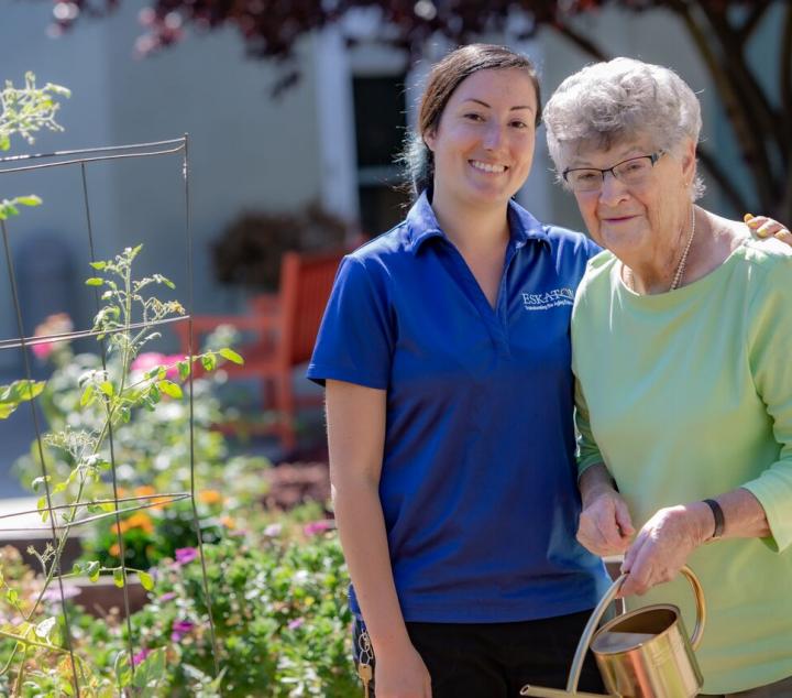 Eskaton staff taking a walk with a resident