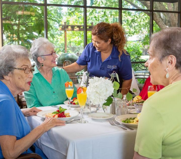 three female resident enjoying a meal in the dining room