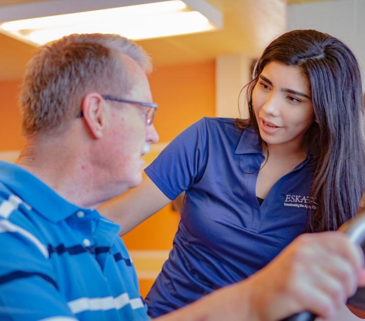 a female staff member talking to a male resident