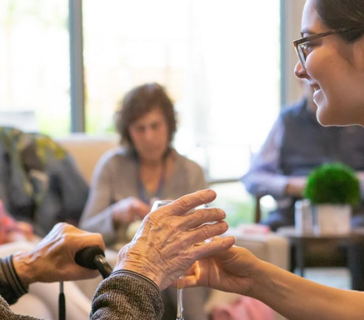 Staff serving residents wine