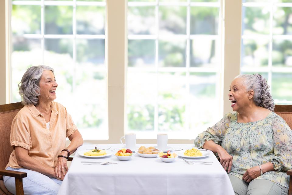 Two women sitting across from each other at a table