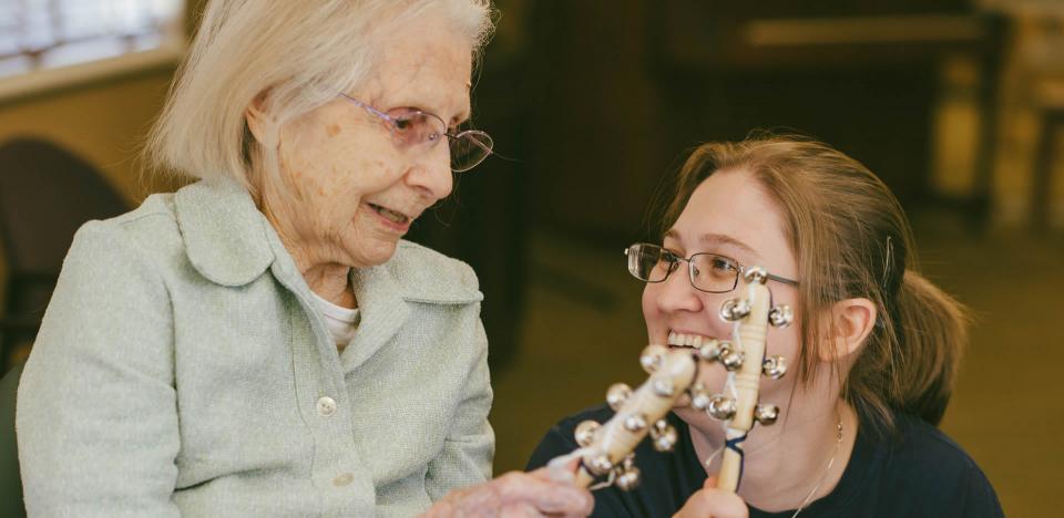 Resident and staff playing with musical instruments