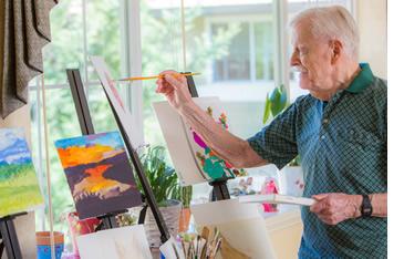 A man painting on canvas 
