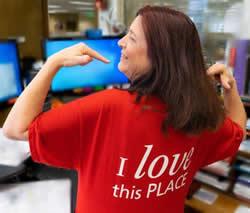 Cindy Powell Eskaton's longest-term employee wearing a red "I love this place" t-shirt