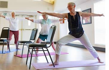 Three women doing Yoga stretches