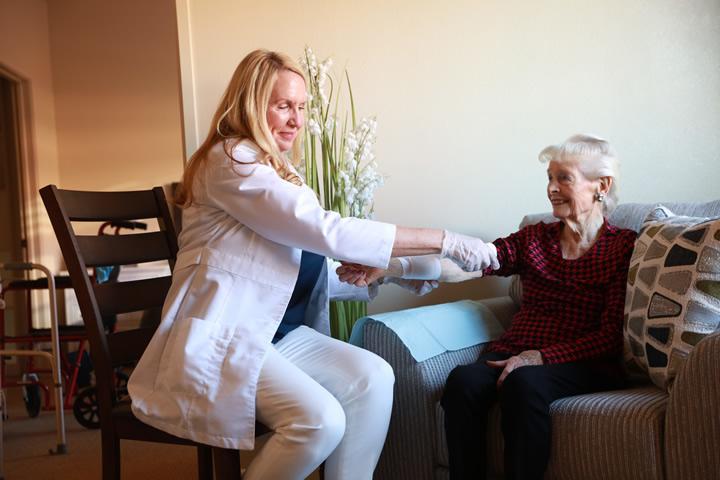 A woman receiving wound care from a Home Healthcare caregiver