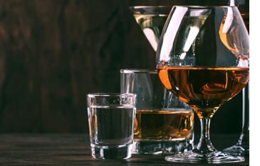 Five glasses with alcohol