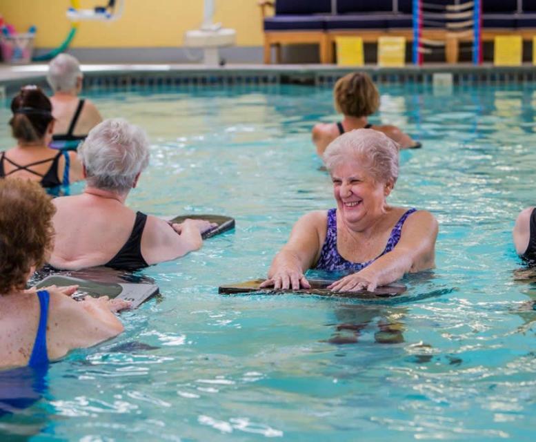 women having fun in an water aerobics class