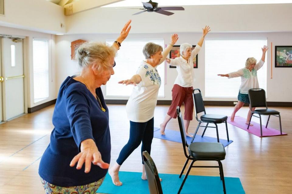 Women in an exercise class doing balancing exercises